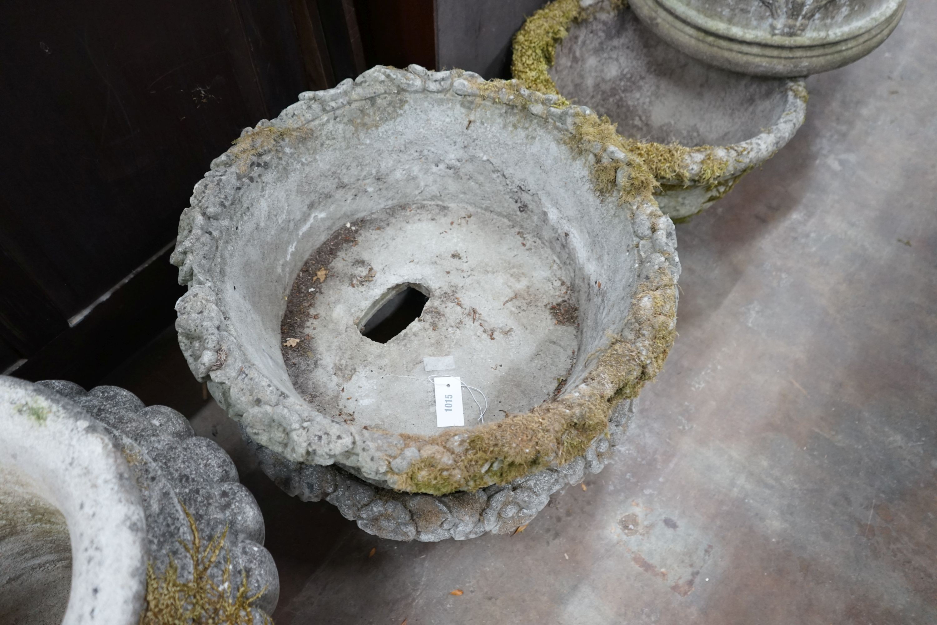 A pair of circular reconstituted stone floral basket garden planters, diameter 62cm, height 24cm